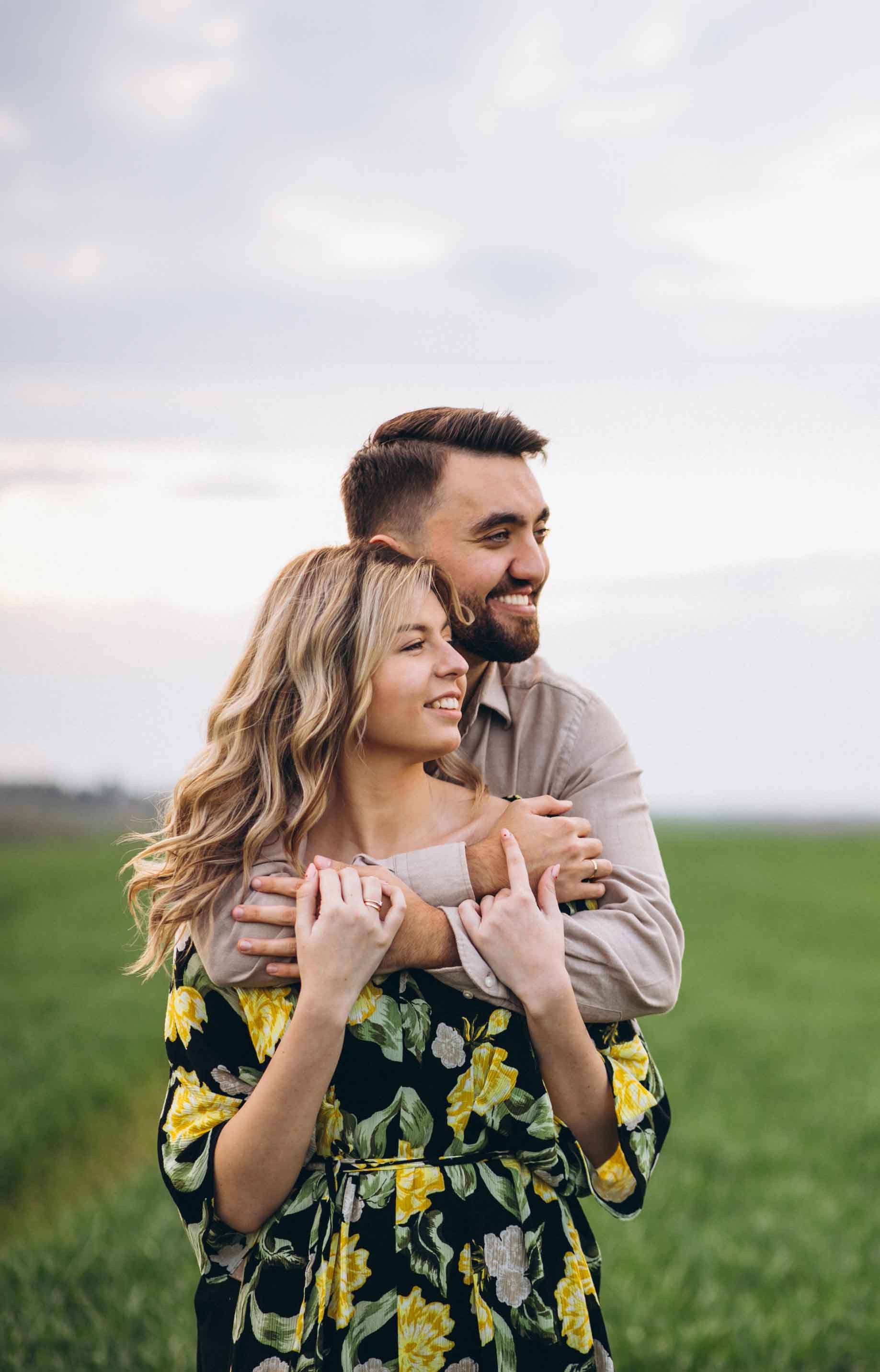 Young couple field with green grass lr